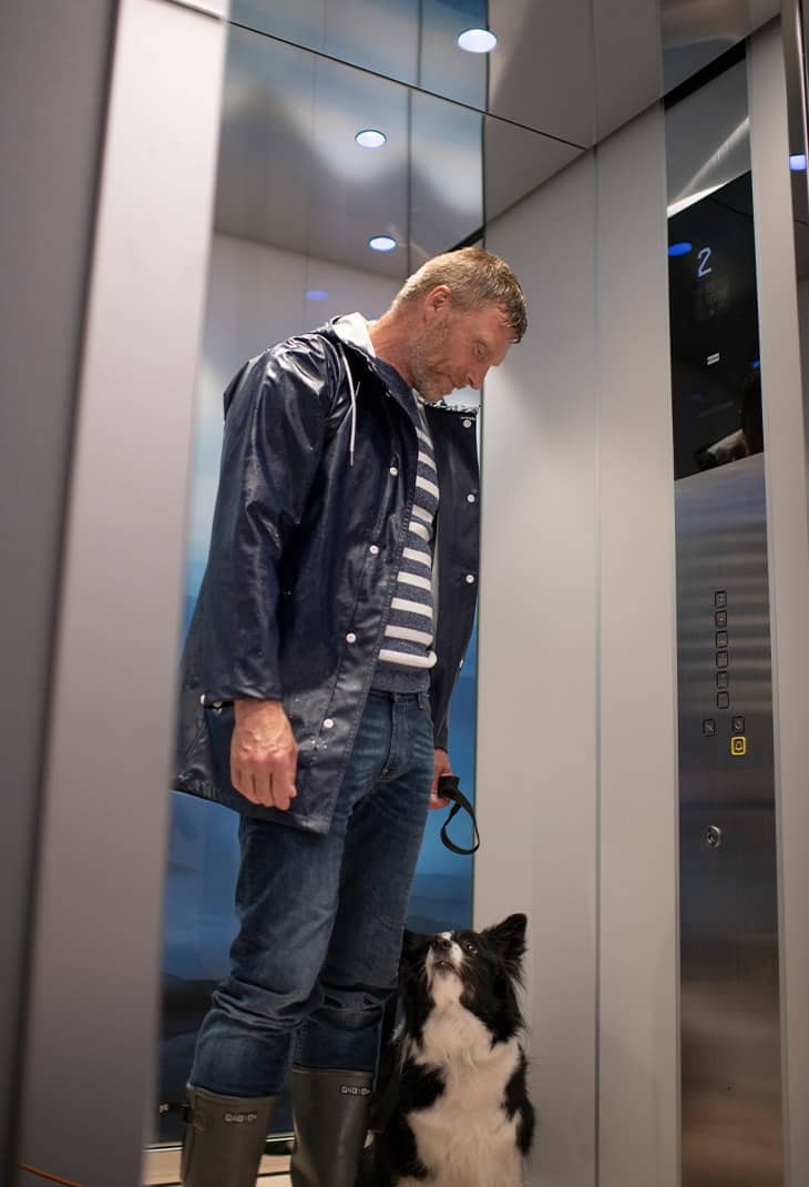 homme et son chien dans un ascenseur
